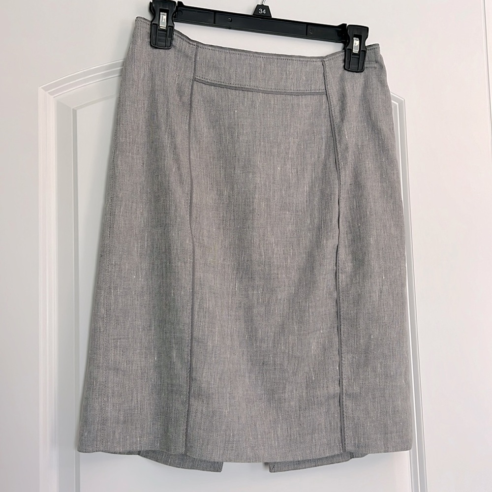 Grey pencil skirt. Invisible zipper with top hook in back.